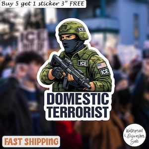 May include: A sticker featuring an illustration of a soldier in a green uniform, helmet, and black face covering, holding a rifle. The text "DOMESTIC TERRORIST" is below the soldier. The sticker also includes the text "ICE" and "Waterproof & Dishwasher Sale."