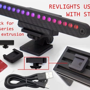 May include: A Revlights USB kit with a carbon fiber-textured light bar featuring purple and red LED lights, a black adjustable stand, a USB cable, two red 3M VHB adhesive squares, and a twist lock for 20 and 40 series aluminum extrusion profiles.