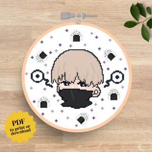 May include: Cross stitch pattern featuring a cartoon character with blonde hair wearing a black mask. The character is surrounded by white rice balls on a white background with purple and blue accents.