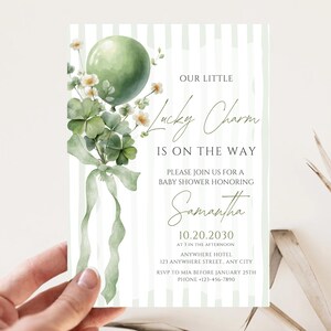 May include: Baby shower invitation with a green balloon, shamrocks, and the text "Our Little Lucky Charm Is On The Way." The invitation is decorated with a watercolor style design and features the name "Samantha."