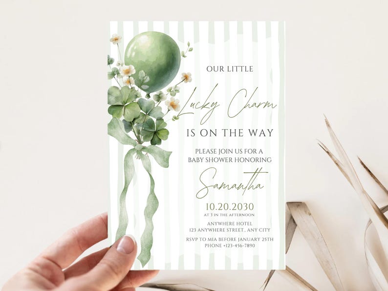May include: Baby shower invitation with a green balloon, shamrocks, and the text "Our Little Lucky Charm Is On The Way." The invitation is decorated with a watercolor style design and features the name "Samantha."