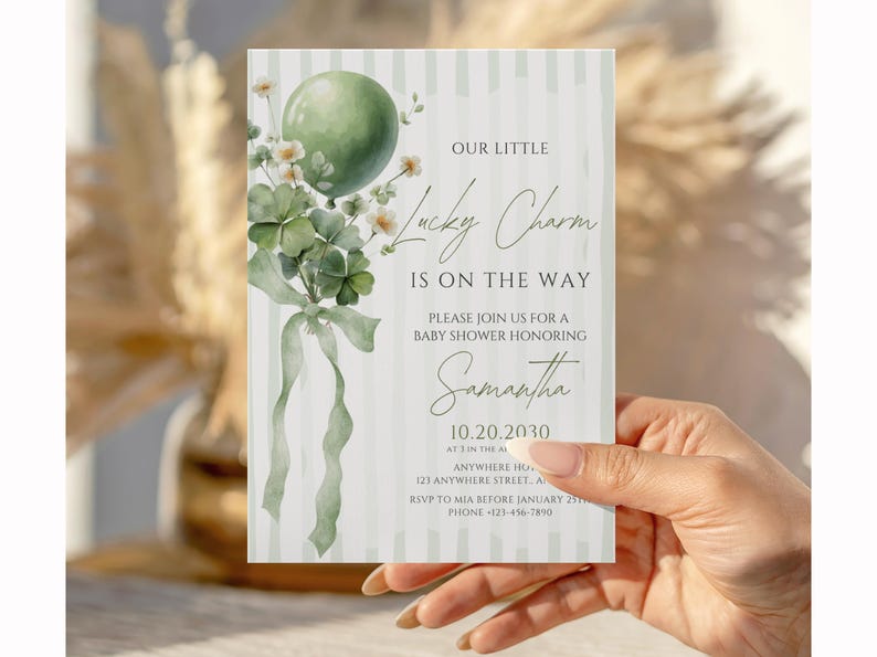 May include: Baby shower invitation with a green balloon, shamrocks, and the text "Lucky Charm is on the Way." The invitation is light green with vertical stripes and features the name "Samantha" and event details.