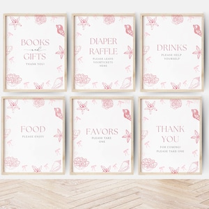 May include: Six printable signs with pink and white seashell and starfish designs. The signs read "Books and Gifts", "Diaper Raffle", "Drinks", "Food", "Favors", and "Thank You".