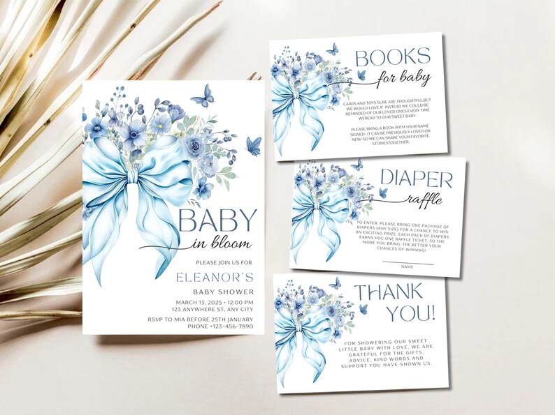 May include: Blue and white baby shower invitation with a watercolor illustration of a blue bow and flowers. The text reads "Baby in Bloom" and includes details for Eleanor's baby shower.