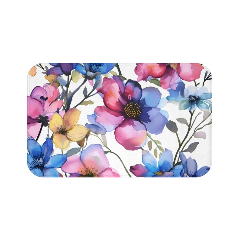 A foam bath mat featuring a lush watercolor painting of vibrant flowers in shades of pink, blue, and yellow, offering a stylish and comfortable addition to bathroom decor.