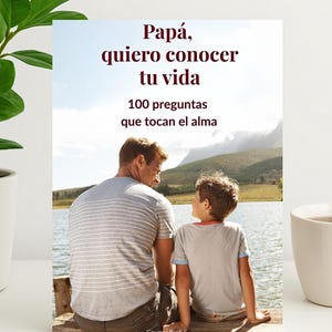 以下が含まれることがあります： 「Papá, quiero conocer tu vida」（お父さん、あなたのことを知りたい）と「100 preguntas que tocan el alma」（魂に触れる100の質問）というテキストが書かれた本の表紙。湖のそばに座っている父と息子の画像。