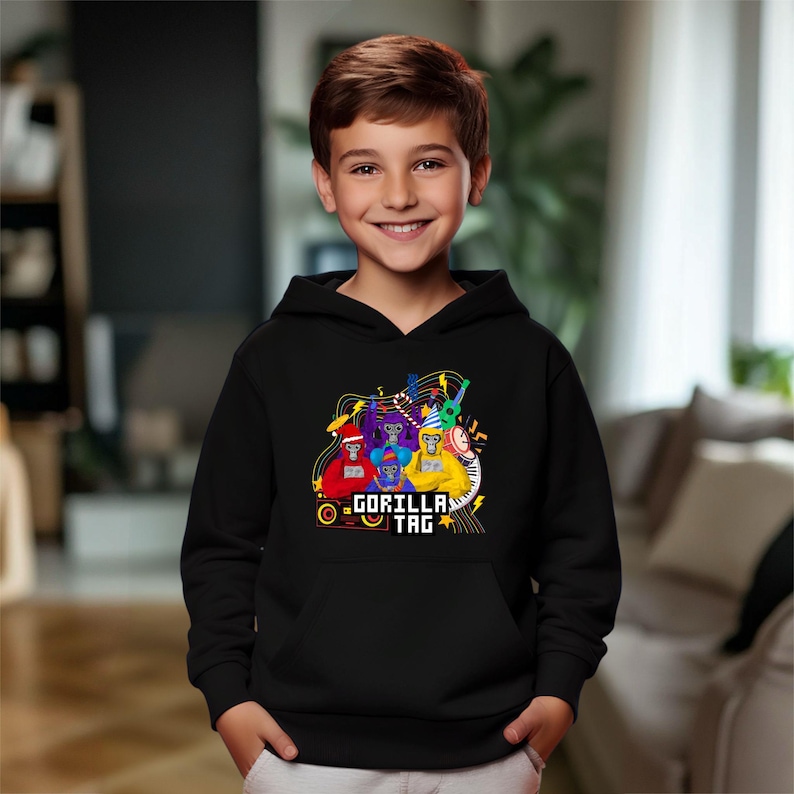 a young boy wearing a black hoodie with a cartoon character on it