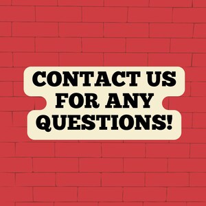 May include: A white sign with rounded corners against a red brick wall background. The sign reads "Contact Us For Any Questions!"