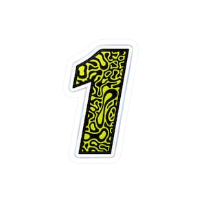 May include: A sticker in the shape of the number one. The number is black with a yellow, abstract pattern. The sticker has a white border with a holographic, iridescent sheen.