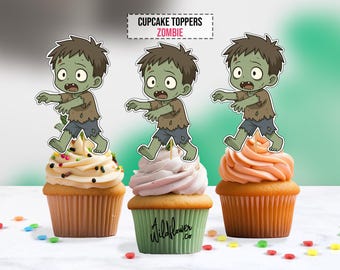May include: Three cupcakes with zombie-themed toppers. Each cupcake has a different frosting color: white with sprinkles, pink, and orange. The toppers are cartoon zombies with green skin and torn clothing. The text "CUPCAKE TOPPERS ZOMBIE" is at the top.