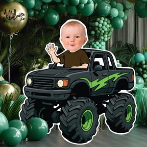 May include: A digital illustration of a baby waving from a black monster truck with green lightning bolt designs. The background includes green balloons and foliage, with a gold balloon that says "Wildflower .co".
