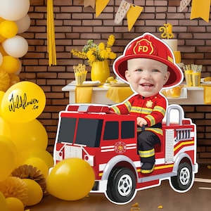 May include: A child's birthday party scene with a red fire truck cutout and a child dressed as a firefighter. The background includes yellow and white balloons, a brick wall, and a table with treats.