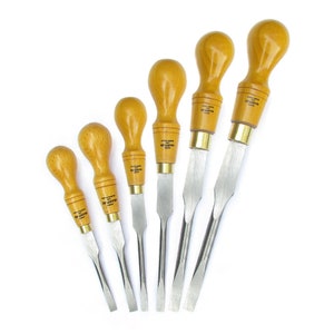 May include: Set of six wood handled screwdrivers with different sizes. The screwdrivers have a brass coloured metal band at the top of the handle and a silver metal blade.