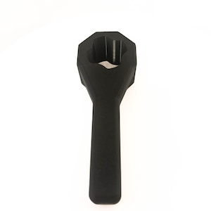 May include: A black, octagonal-shaped tool with a long handle. The tool has a hollow center with a unique design. The handle is smooth and rounded. The tool is likely used for tightening or loosening bolts or nuts.