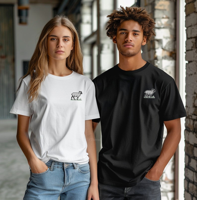 May include: Two people wearing t-shirts with a small embroidered image of a sheep on the front. The person on the left is wearing a white t-shirt and the person on the right is wearing a black t-shirt.