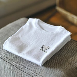 May include: A white t-shirt with a small embroidered image of a sheep on the front.