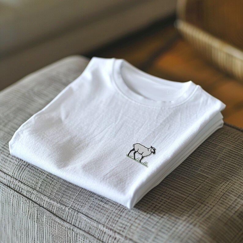 May include: A white t-shirt with a small embroidered image of a sheep on the front.
