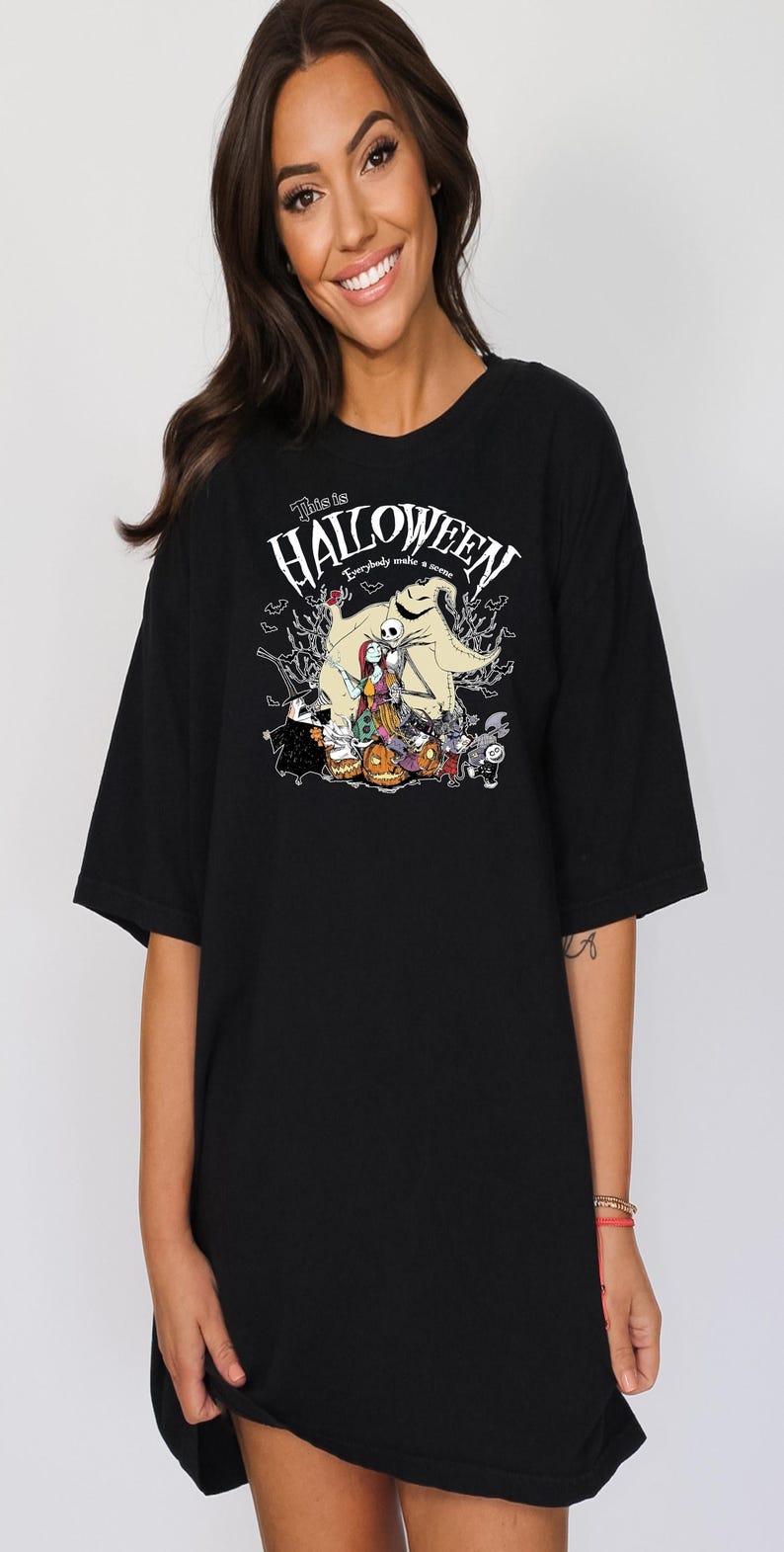 Op de afbeelding: Zwart T-shirt met een afbeelding uit "The Nightmare Before Christmas". Het ontwerp bevat Jack Skellington, Sally en andere personages met de tekst "This is Halloween". Een griezelig ontwerp voor fans van de film.