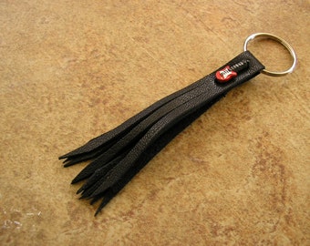 Black Leather tassel keychain with a handmade Peruvian Ceramic guitar bead, and a silver bead,  tassel is 4.25" long, on a 1" silver keyring