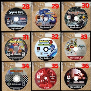 May include: Collection of nine video game discs, including titles like "Silent Hill," "Sonic Riders," and "Mortal Kombat." The discs are for PlayStation 2 and GameCube consoles, featuring colorful game art and logos. Each disc is in its original case.