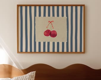 May include: A white and blue striped bedspread with a white and blue striped pillow and a framed print of two red cherries on a blue and white striped background.