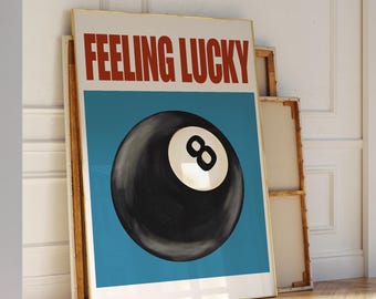 May include: A poster with a blue background and the text "Feeling Lucky" in red letters. A black and white eight ball is in the center of the poster.