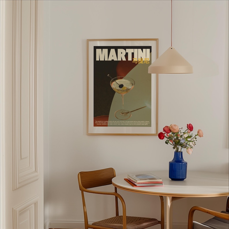 May include: A framed poster with the text "MARTINI" in bold, gold lettering. The poster features a martini glass with a cherry and olive, set against a red, black, and green background.