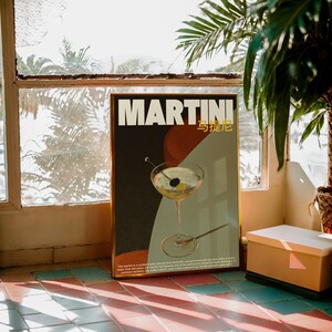 May include: A vintage-style poster with a martini glass filled with a green liquid and a cherry. The poster is titled "MARTINI" in white text with the Chinese characters for "martini" in gold text below. The poster has a black, red, and blue background.