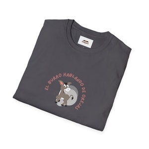 May include: A dark gray t-shirt with a cartoon donkey and the text "El Burro Hablando De Orejas" in a circle.