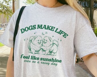 May include: Gray t-shirt with a graphic of two dogs and the text "DOGS MAKE LIFE feel like sunshine even on a rainy day."