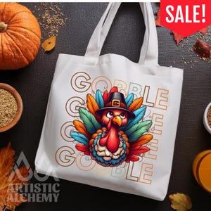 May include: A white canvas tote bag featuring a colorful illustration of a turkey wearing a black pilgrim hat. The turkey has vibrant red, blue, orange, and green feathers. The text GOBBLE GOBBLE is printed in a large, outlined font behind the turkey.