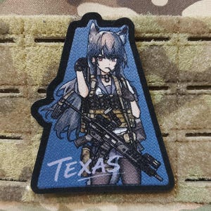 May include: A patch featuring an anime-style character with wolf ears, holding a rifle. The character is set against a blue background with the word "Texas" at the bottom. The patch has a black border and is displayed on a camouflage background.