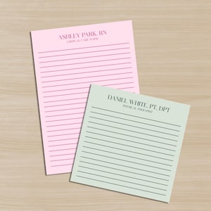 May include: Two lined notepads, one pink and one green, rest on a light wood surface. The pink notepad has the text "ASHLEY PARK, RN CRITICAL CARE NURSE" at the top. The green notepad has the text "DANIEL WHITE, PT. DPT PHYSICAL THERAPIST".