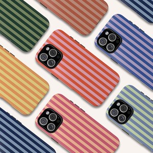 May include: A collection of iPhone cases with different striped patterns. The cases are in various colors, including green, orange, pink, blue, and light green. Each case has a black camera lens.