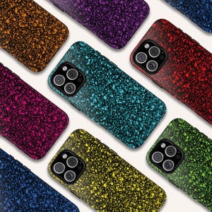 May include: A collection of colorful phone cases with a speckled design. The cases are in various colors, including orange, purple, teal, red, pink, blue, yellow, and green. Each case has a black border and a camera cutout.