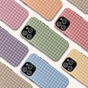 May include: A selection of mobile phone cases in a variety of pastel colours, each featuring a white grid pattern. The cases include pink, orange, green, red, purple, blue, and yellow. Each case has a camera aperture and a black edge.