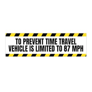 May include: A white rectangular sign with black text and yellow and black hazard stripes. The text reads: "TO PREVENT TIME TRAVEL VEHICLE IS LIMITED TO 87 MPH."
