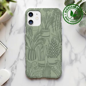 May include: A green phone case with a pattern of potted plants and leaves. The case has a cutout for the camera lens and a raised lip around the edges to protect the screen.