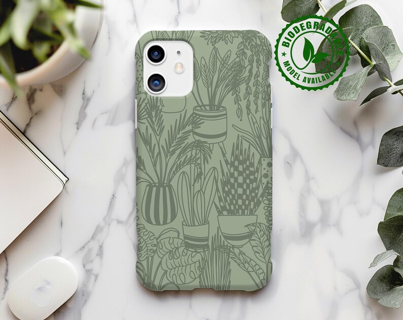 May include: A green phone case with a pattern of potted plants and leaves. The case has a cutout for the camera lens and a raised lip around the edges to protect the screen.