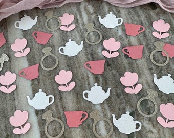 Puede incluir: Confeti rosa y blanco con diseños de taza de té, tetera, flor y anillo. El confeti es perfecto para una despedida de soltera o una fiesta de té.