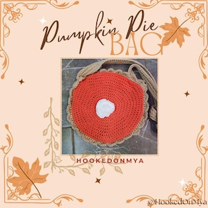 May include: A crocheted bag in the shape of a pumpkin pie, with an orange filling, a tan crust, and a white cream dollop. The text "Pumpkin Pie BAG" is displayed at the top. The bag has a tan strap.