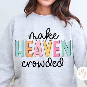 May include: A gray sweatshirt with the text "make HEAVEN crowded" in colorful letters. The text is in a playful, handwritten font.