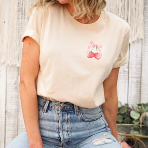Coquette Cherry Pocket Design Shirt | Cute Coquette Pink Bow Cherries | Pink Bow T-Shirt | Cherries tee | Cutesy pink bow shirt