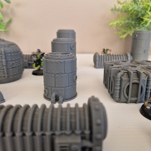 May include: A collection of gray, 3D printed, steampunk-style pipes and tanks. The pipes are made of a smooth, gray plastic and have a variety of shapes and sizes. The tanks are also made of a smooth, gray plastic and have a variety of shapes and sizes.