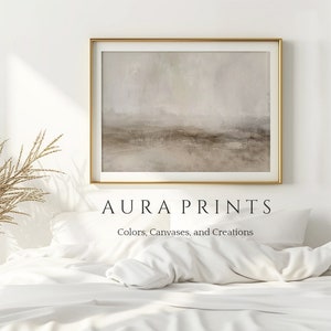 Puede incluir: Una pintura abstracta enmarcada en tonos marrones y grises apagados cuelga sobre una cama blanca con un edredón y almohadas blancas. El texto "AURA PRINTS Colores, Lienzos y Creaciones" está debajo de la pintura.