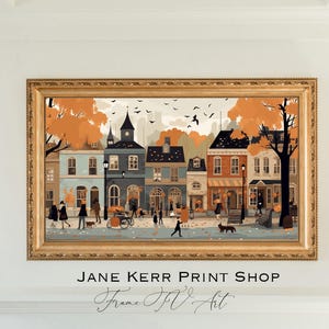 May include: A framed illustration of a quaint town street scene with colorful buildings, fall foliage, and people walking. The text "JANE KERR PRINT SHOP" is at the bottom of the image.