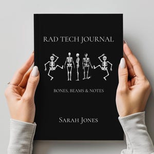 May include: A black journal titled RAD TECH JOURNAL with the subtitle BONES, BEAMS & NOTES and the author name SARAH JONES. The cover features white illustrations of four human skeletons in various poses, including two dancing skeletons.