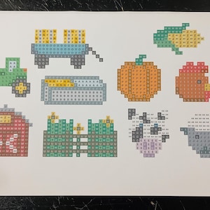 May include: A set of nine pixel art images depicting farm animals, a barn, a tractor, a truck, corn, a pumpkin, and a chicken. The images are made up of small squares of different colors.