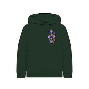 May include: A dark green hoodie with a small floral design on the left chest. The flowers are a mix of purple, pink, and yellow. The hoodie has a hood and long sleeves.