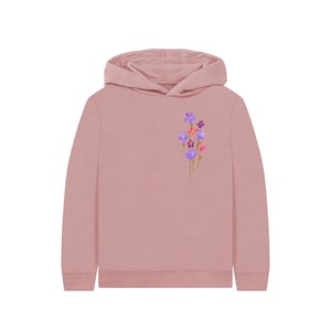 May include: A dusty rose hoodie with a floral design. The hoodie features a cluster of purple, pink, and orange flowers with green stems on the left chest. The hoodie has a hood and long sleeves.